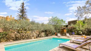 A swimming pool with lounge chairs and a stone wall. - 17th-century house below Saint-Montan castle (Saint-Montan)