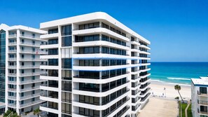 A multi-story hotel with balconies overlooking a beach. - Ocean/River View | Heated Pool | Royal Atlantic 8D (Daytona Beach)