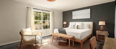 A hotel room with a bed, a desk, a chair, a window, and a wall-mounted lamp.