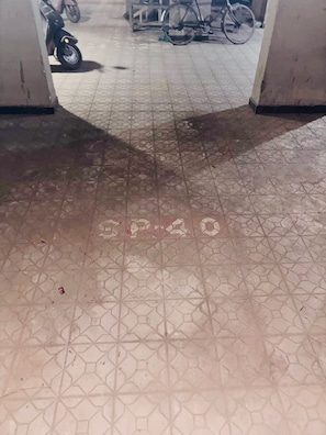 A tiled floor with a geometric pattern and a partially visible doorway leading to another room.