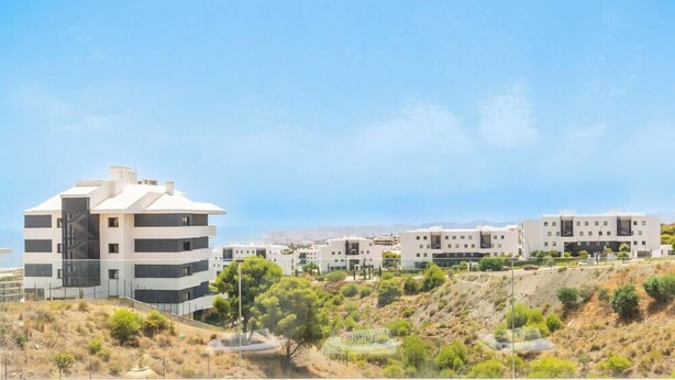 A modern residential area with multi-story buildings, flat-roofed structures, and a hilly landscape. - Casa Aura Higuerón  -Modern Luxury Apartment with Spectacular valley and sea views- Higueron - Fuengirola (Fuengirola)