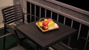 A small table with a basket containing fruit and a white cloth. - NJ Homes Bunga  (Kampala)