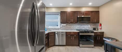 Fully equipped kitchen with modern appliances and ample counter space for preparing meals