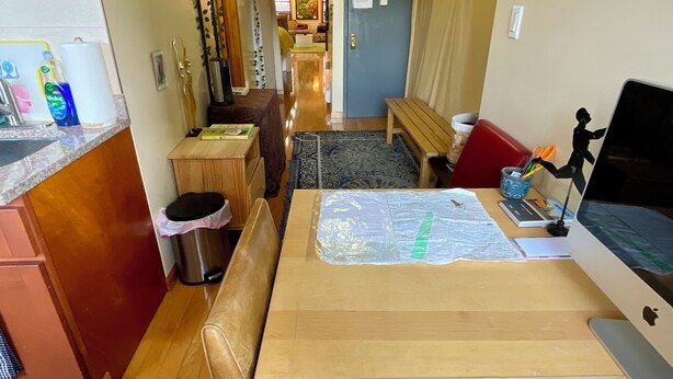 A kitchen with wooden cabinets, a sink, and a countertop with cleaning supplies. - GORGEOUS HUGE LOFT in the LES/CHINATOWN! (New York)