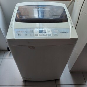 A white washing machine with a control panel and a label indicating a 'Premium Wind Up System.' - Spacious, comfortable 2-bedroom apartment, Sopocachi - La Paz, Bolivia (La Paz)