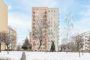 A multi-story residential building with a central courtyard and snow-covered ground. - Stay in Warsaw Center (Warsaw)
