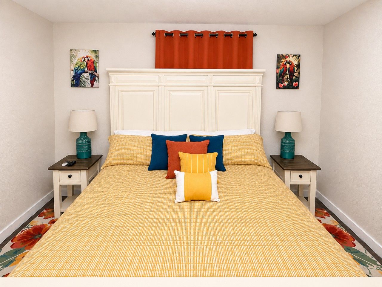 A bedroom with a large bed, two nightstands, a headboard, and two wall-mounted lamps.