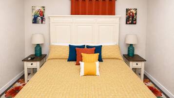A bedroom with a large bed, two nightstands, a headboard, and two wall-mounted lamps.