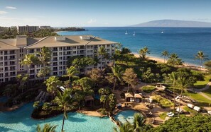 A resort with a large building, a swimming pool, palm trees, and a view of the ocean. - Westin Kaanapali Ocean Resort Villas (Lahaina)