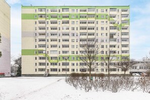A multi-story residential building with a symmetrical facade, balconies, and a central staircase. - Warsaw Flat Near Old Town (Warsaw)