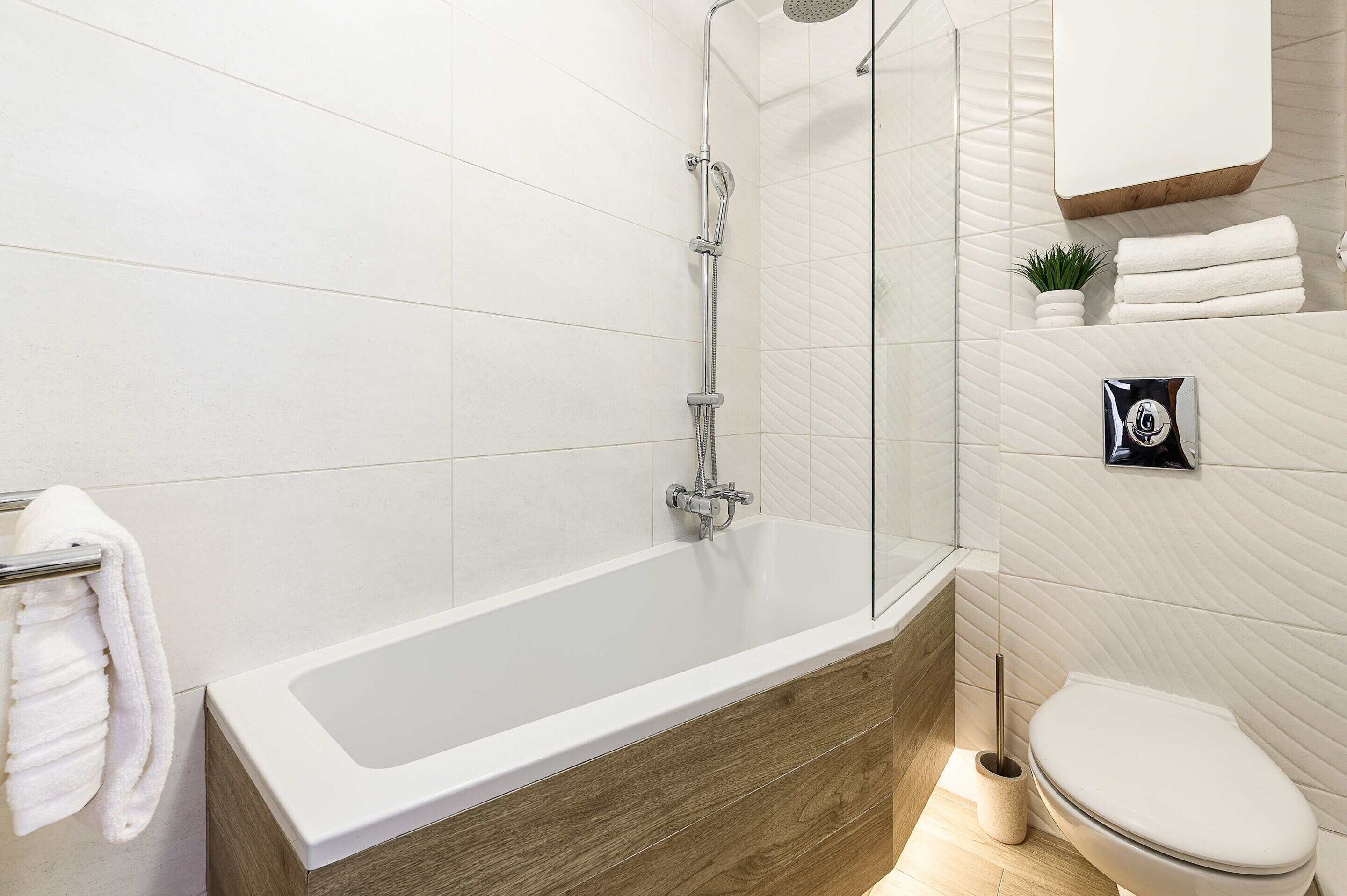 Un baño moderno con una bañera independiente, un inodoro y una zona de ducha.