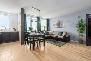 Un appartement moderne comprenant un coin repas, une cuisine et un salon.