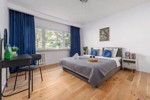 Une chambre à coucher moderne avec un lit, un bureau et une chaise.