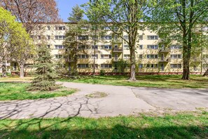 A multi-story residential building with a central courtyard, surrounded by trees and greenery. - Warsaw City Stay for Families (Warsaw)