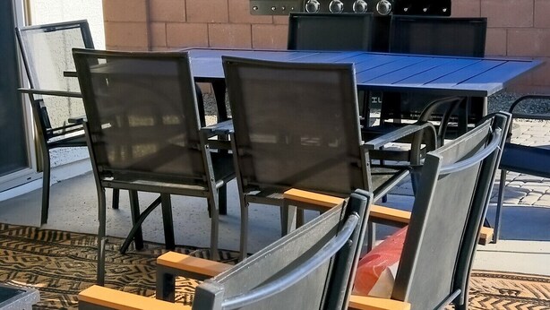 An outdoor seating area with a grill and chairs. - Star Light, Estrella Mountain Ranch (Goodyear)