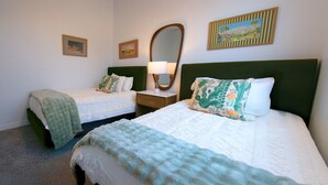 A hotel room with two beds, a nightstand with a lamp, and wall art. - Star Light, Estrella Mountain Ranch (Goodyear)