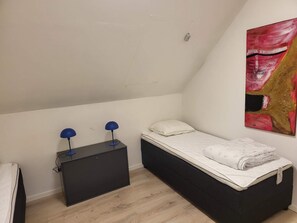 A small, single-bed room with a desk and two lamps. - 4 Star Holiday Home in Allinge (Allinge)