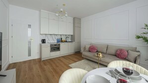 A modern kitchen with white cabinetry, a marble countertop, and a built-in oven. - New House With Pool Near Beach (Warsaw)