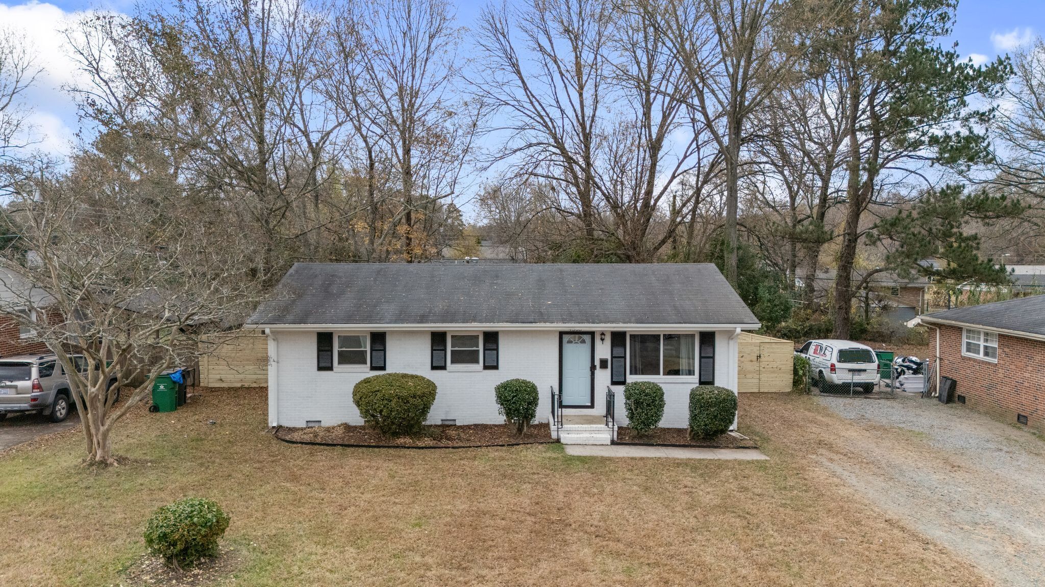 A single-story house with a front porch, a garage, and a driveway.