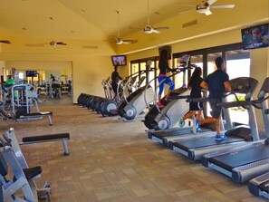 A gym with treadmills, stationary bikes, and weight machines. - Luxury 4BR Villa | Pool, Jacuzzi & Golf Views (Cabo San Lucas)