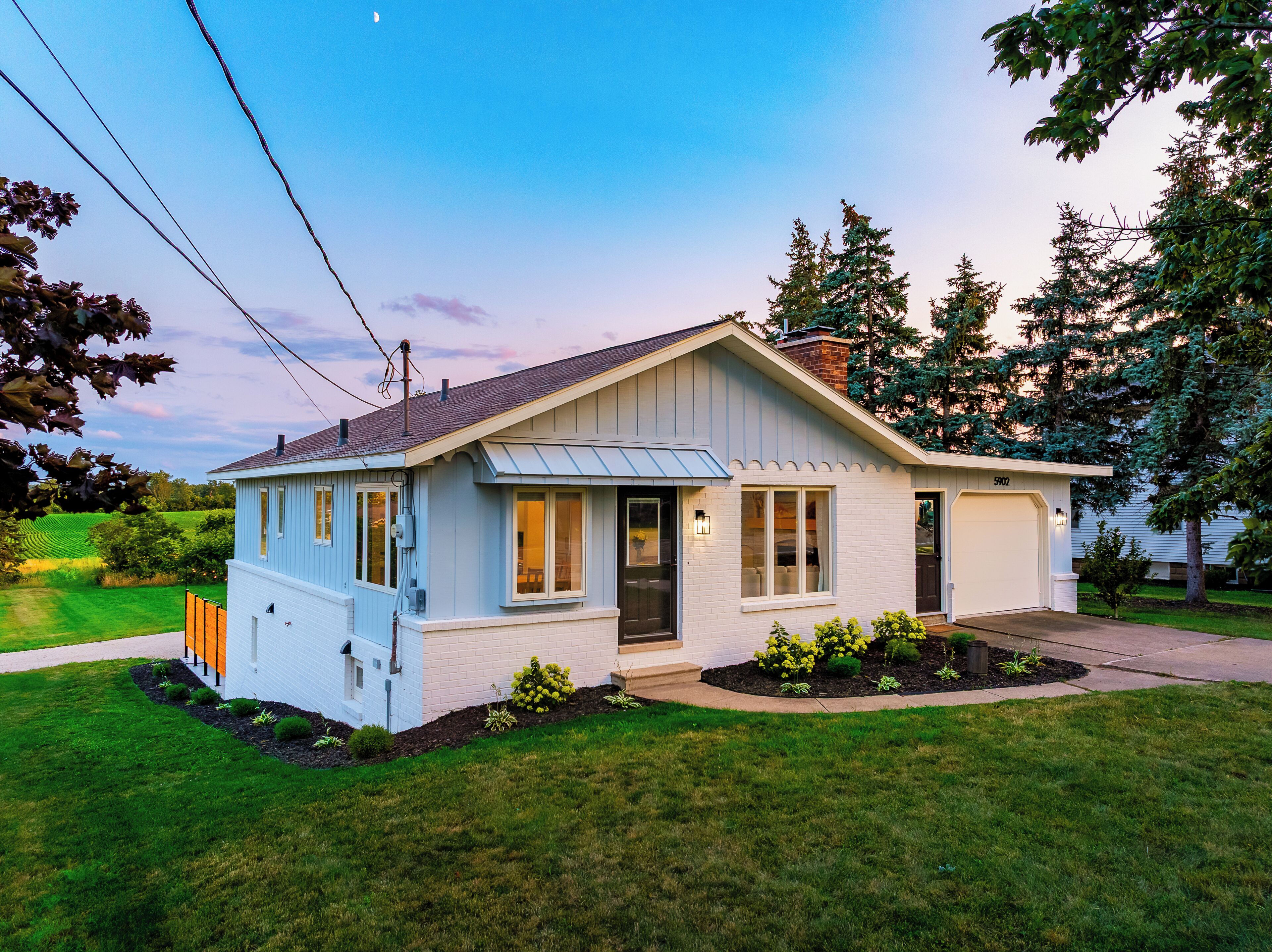A single-story house with a gabled roof, a front porch, and a garage.