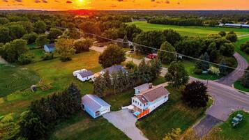 A residential area with houses, a road, and a sunset.