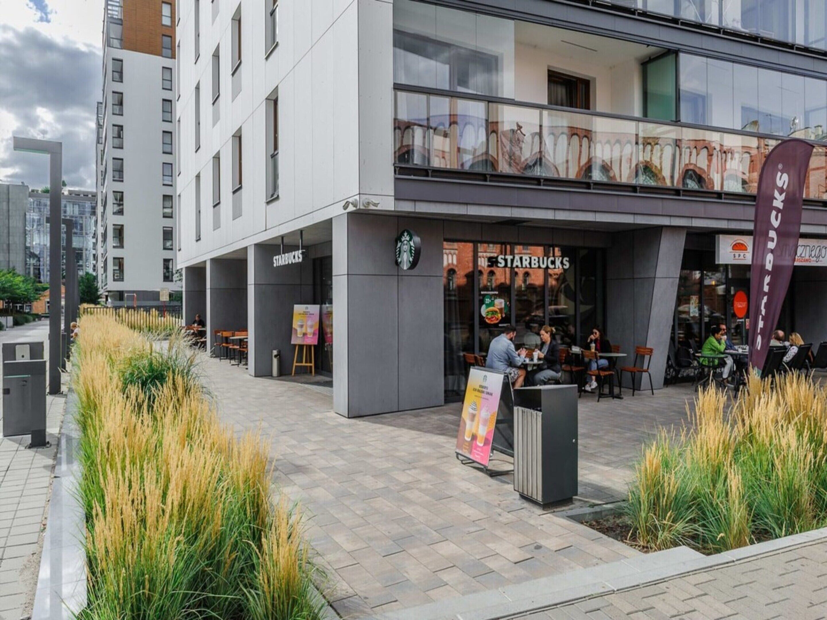 A modern building with a Starbucks café on the ground floor.