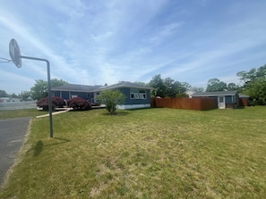 A residential property with a house, a fenced yard, and a satellite dish. - Blue Anchor Beach House (Middle Township)