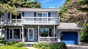 A two-story house with a front porch, a garage, and a well-maintained lawn. - Lake Alexander Hideaway - Waterfront, Private Dock (Cushing)