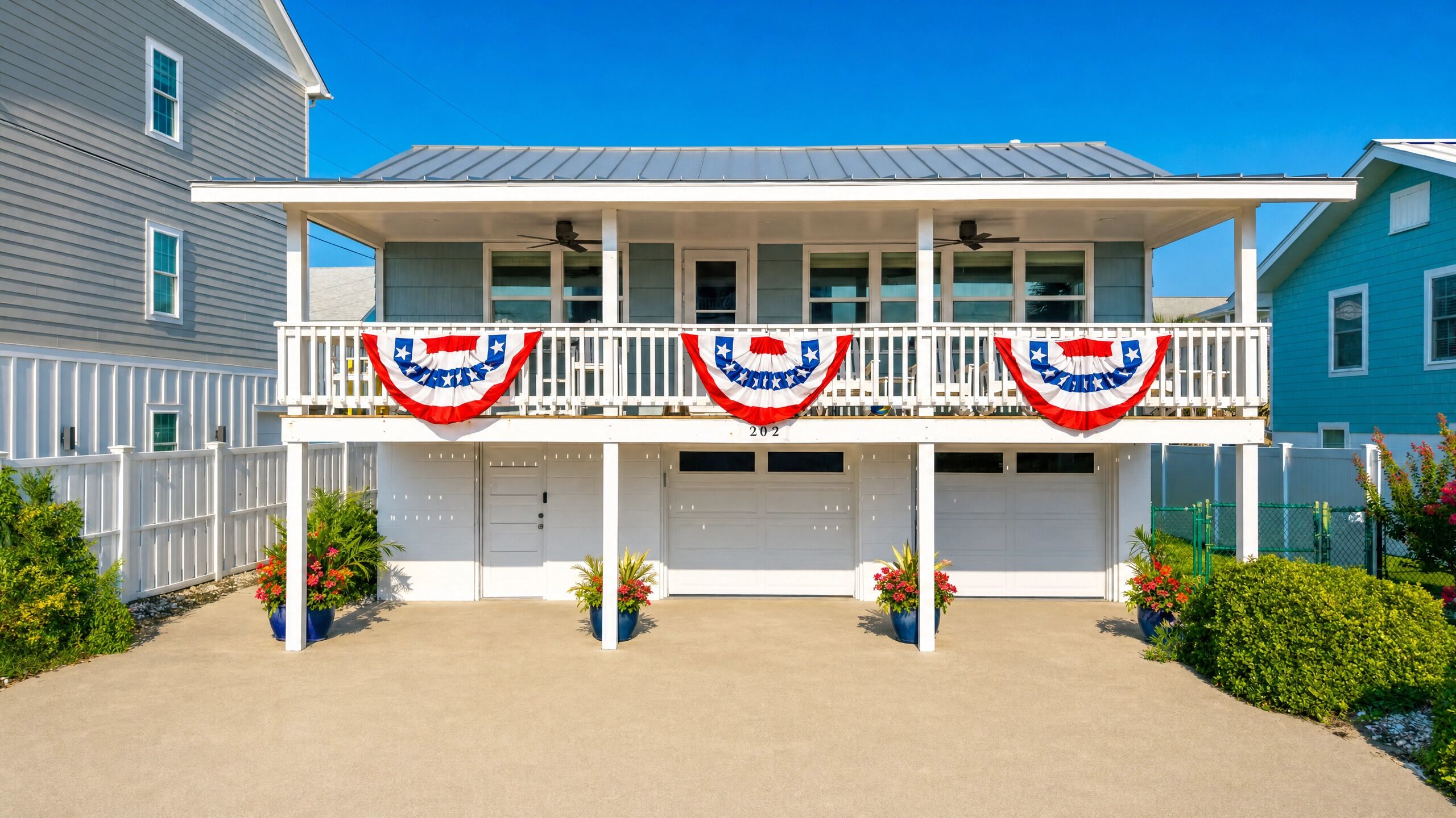A two-story house with a balcony, white railings, and a garage.