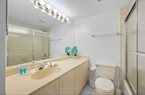 A bathroom with a large mirror, vanity, sink, and toilet. - The Divine Tides Condo 5 Min Walk to Jupiter Beach (Jupiter)