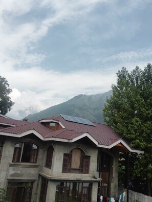 A building with a sloped roof, multiple windows, and a visible solar panel. - sennin evin & resorts by MH (Srinagar)