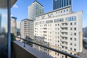 A multi-story building with a modern architectural design, featuring balconies and large windows. - Central Warsaw Home With Garage (Warsaw)