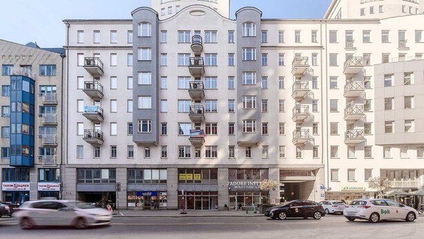 A multi-story hotel with balconies, a ground-level restaurant, and a visible entrance. - Central Warsaw Home With Garage (Warsaw)