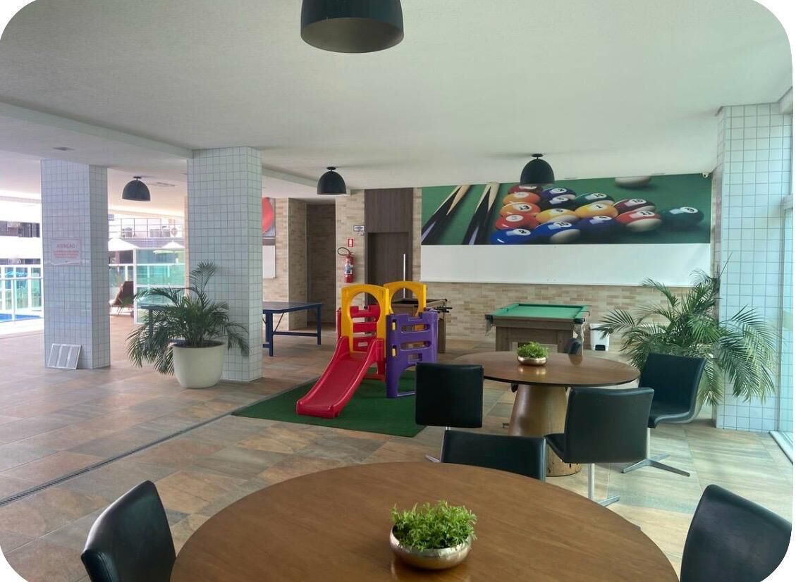 A children's play area with a slide, a pool table, and a billiards table.