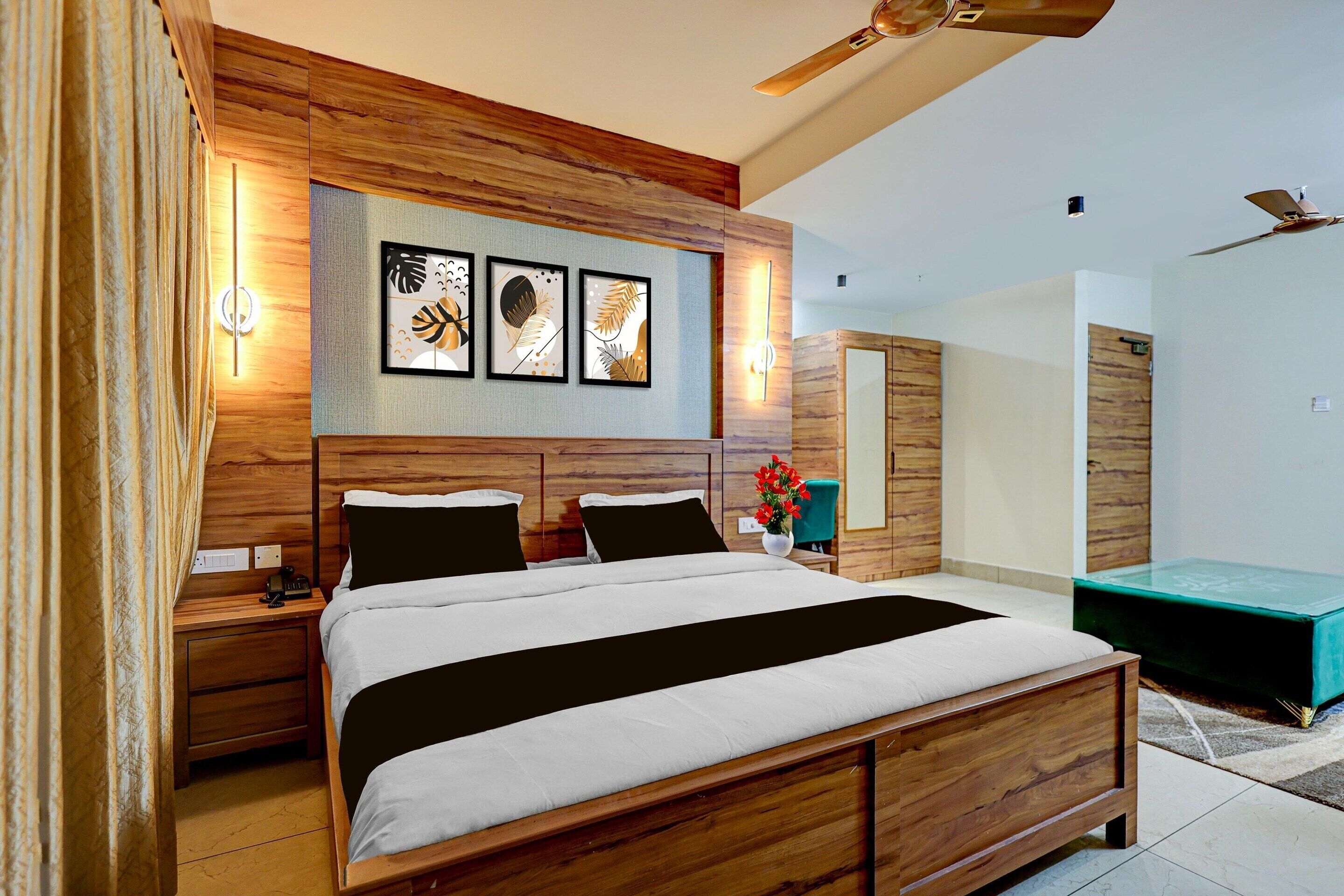 A bedroom with a wooden bed, bedside tables, a nightstand, a mirror, and a ceiling fan.