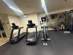 A gym with treadmills, a stationary bike, and weight machines. - Modern apartment located in Aldea Zama with a pool, gym, and green spaces. (Tulum)