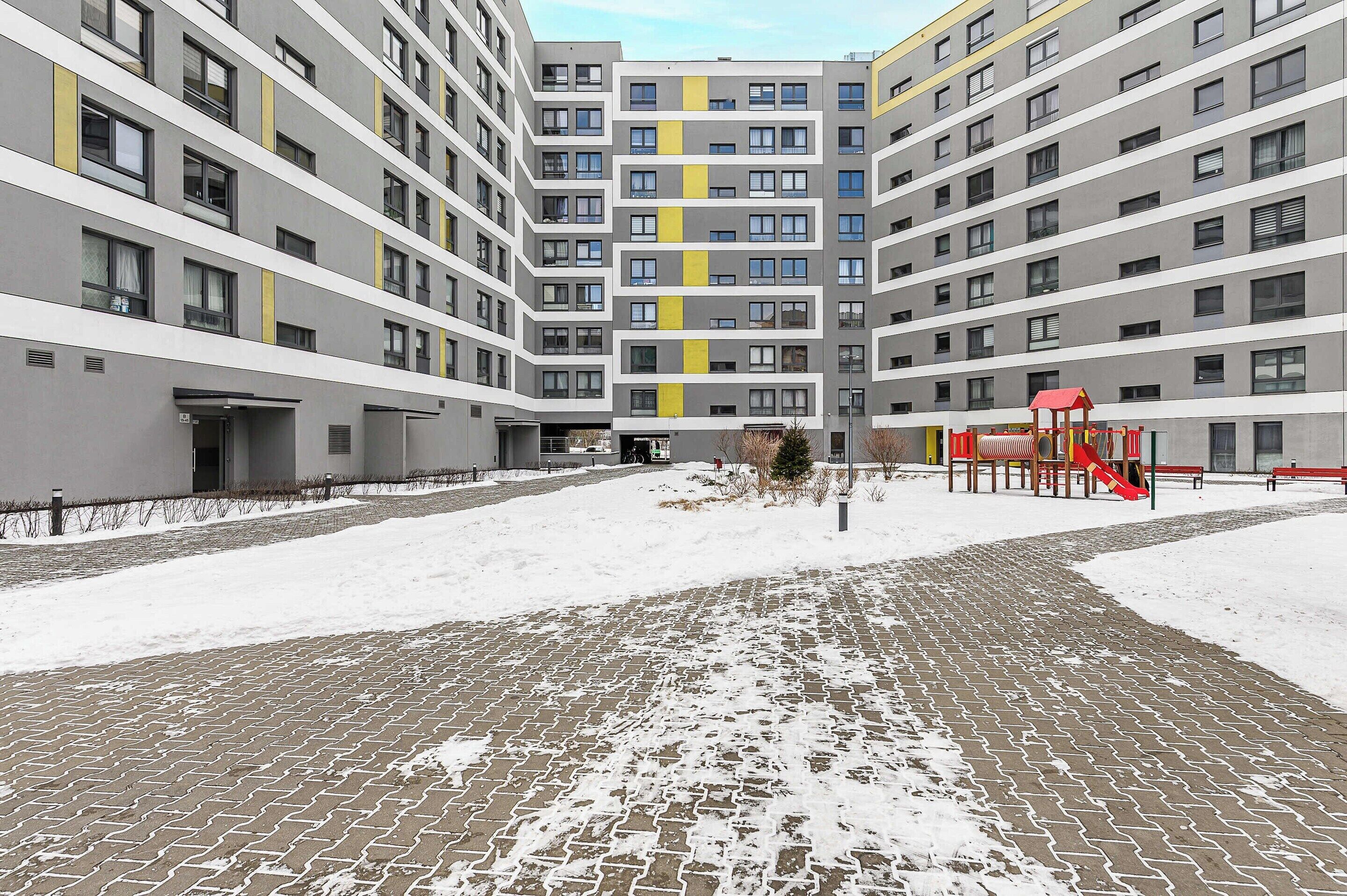 A multi-story residential building with a central courtyard.