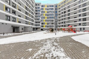 A multi-story residential building with a central courtyard. - Family Flat With Garden (Warsaw)