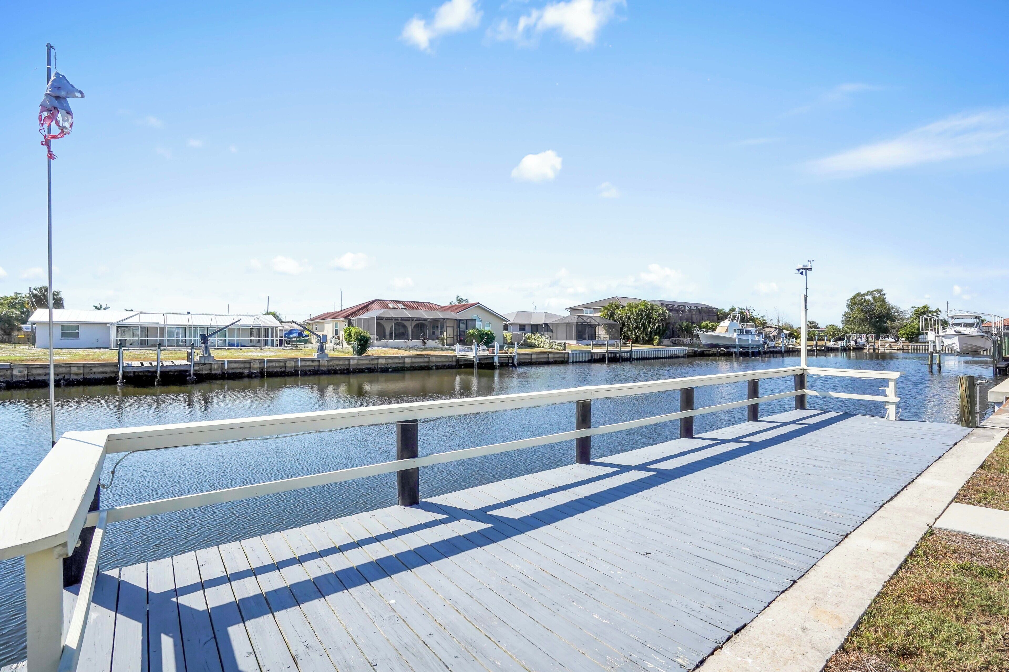 A waterfront property with a dock, a marina, and residential buildings.