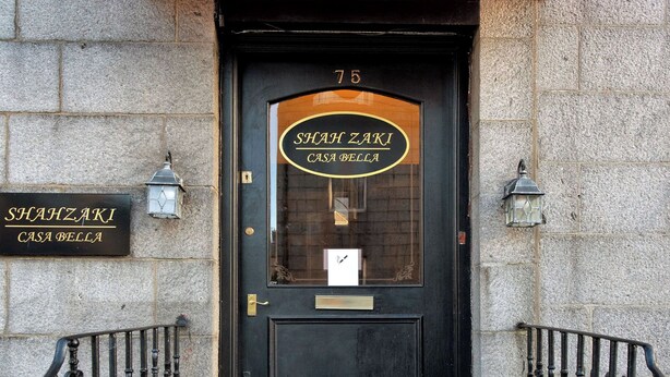 A black door with a red awning and a sign reading 'SHAH ZAKI CASA BELLA.' - RM4 - Perfect 1-bedroom, Shower inside room with free onsite parking. (Aberdeen)