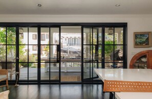 A room with a sliding glass door leading to an outdoor patio area. - Beach House/Rare Rooftop Deck/9 Homes from sand/few blocks to Down Town (Manhattan Beach)