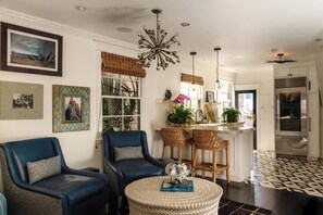 A living room with two blue armchairs, a round coffee table, and a modern chandelier. - Beach House/Rare Rooftop Deck/9 Homes from sand/few blocks to Down Town (Manhattan Beach)