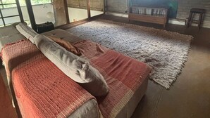 A spacious room with a large bed, a wooden ceiling, and a view of greenery outside. - Cozy property for the whole family. 50km from São Paulo. (Caucaia do Alto)