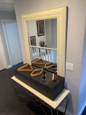 A bathroom vanity with a large mirror, a black countertop, and a white base. - 5BR Pool House + Billiards · Up to 15 Guests (Las Vegas)