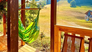 A wooden deck with a hammock and a view of a mountain landscape. - Chalet de la Garde - Alpe d'Huez Resort (La Garde)