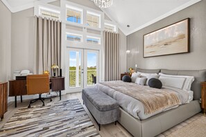 A bedroom with a large bed, a desk, and a view of the outdoors. - The Pearl Sunset Haven | Luxury Spa Retreat (Seminole)