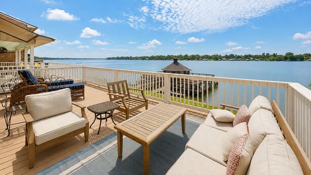 A deck with outdoor furniture, a gazebo, and a view of a lake. - False River Waterfront Escape in Charming New Roads (New Roads)
