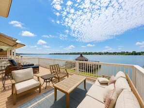 A deck with outdoor furniture, a gazebo, and a view of a lake. - False River Waterfront Escape in Charming New Roads (New Roads)
