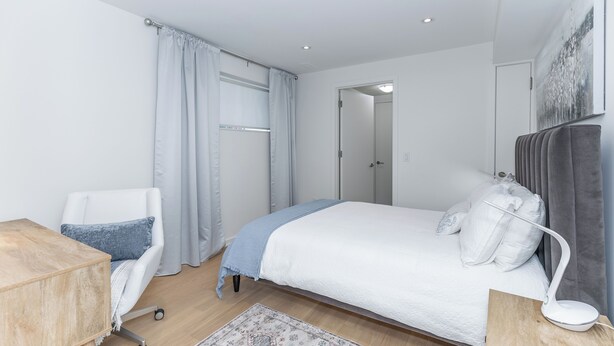 A modern bedroom with a bed, a desk, a chair, and a bedside table. -  Bright, Cozy, Separate Entrance, Guest Room, Walk.: Subway, Shop, restaurants.. (Toronto)
